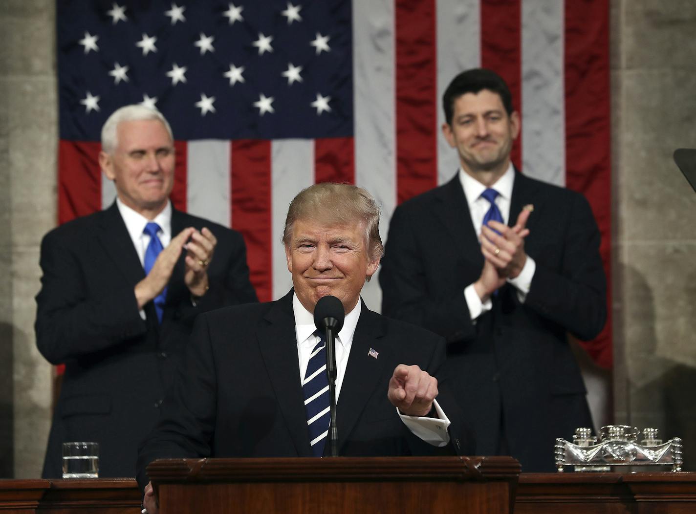 President Donald Trump, flanked by Vice President Mike Pence and House Speaker Paul Ryan of Wis., gestures on Capitol Hill in Washington, Tuesday, Feb. 28, 2017, before his address to a joint session of Congress. (Jim Lo Scalzo/Pool Image via AP) ORG XMIT: MIN2017030112060518