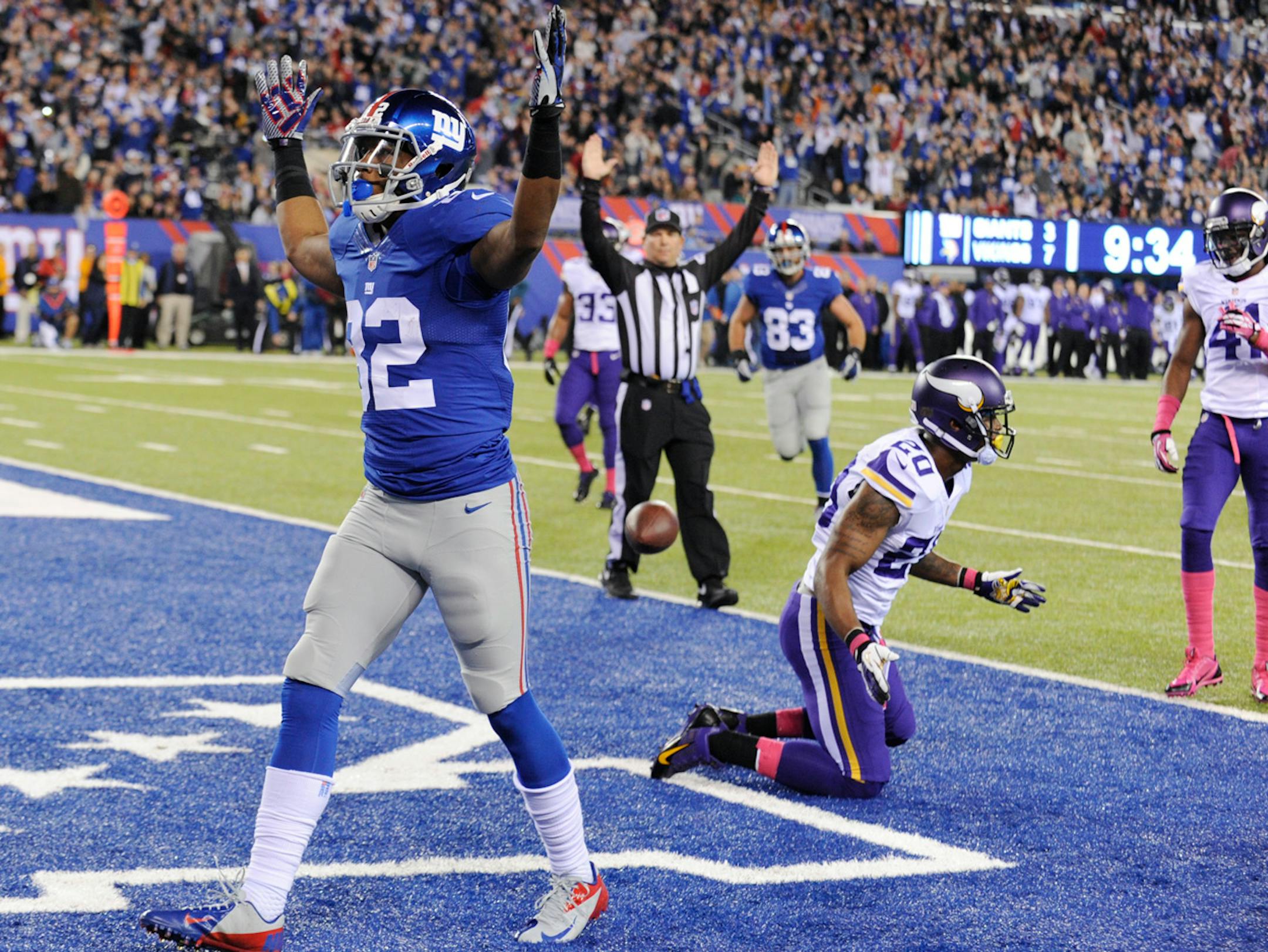 New York Giants wide receiver Rueben Randle (82) celebrates after catching a pass for a touchdown as Minnesota Vikings cornerback Chris Cook (20) and Mistral Raymond (41) react during the first half of an NFL football game Monday, Oct. 21, 2013 in East Rutherford, N.J.