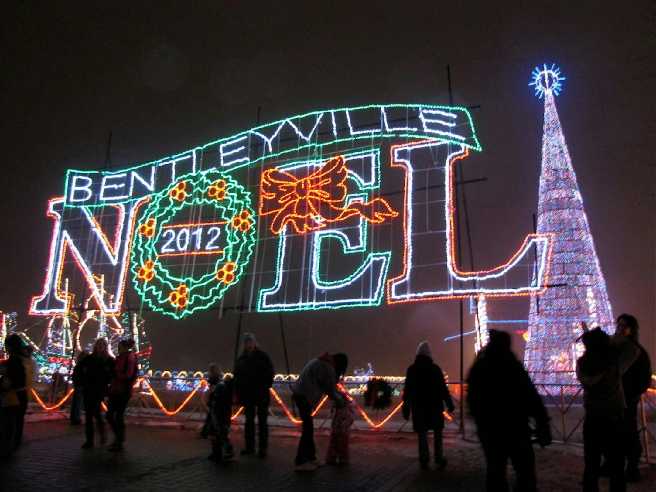 Visitors look across Duluth's Bayfront Festival Park, where a 12-story tree towers above Bentleyville's large holiday light display.