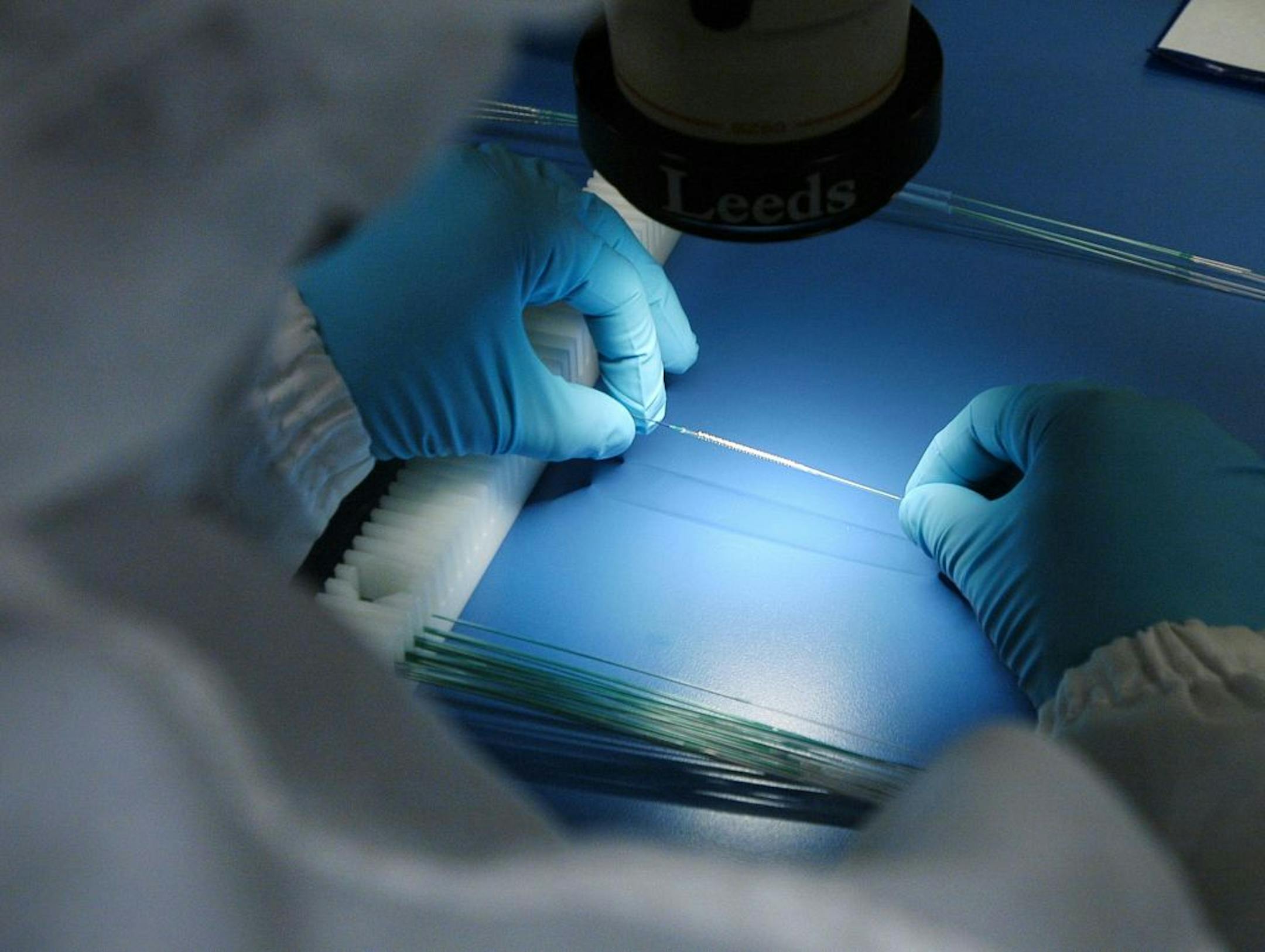A worker inspected Express2 Stent delivery systems at Boston Scientific's Maple Grove facility. Boston Sci, which employs thousands of Minnesotans, reported first-quarter net income of 8 cents a share.