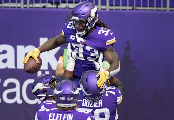 Vikings running back Dalvin Cook celebrated with teammates after scoring a touchdown in the first quarter against the Packers.