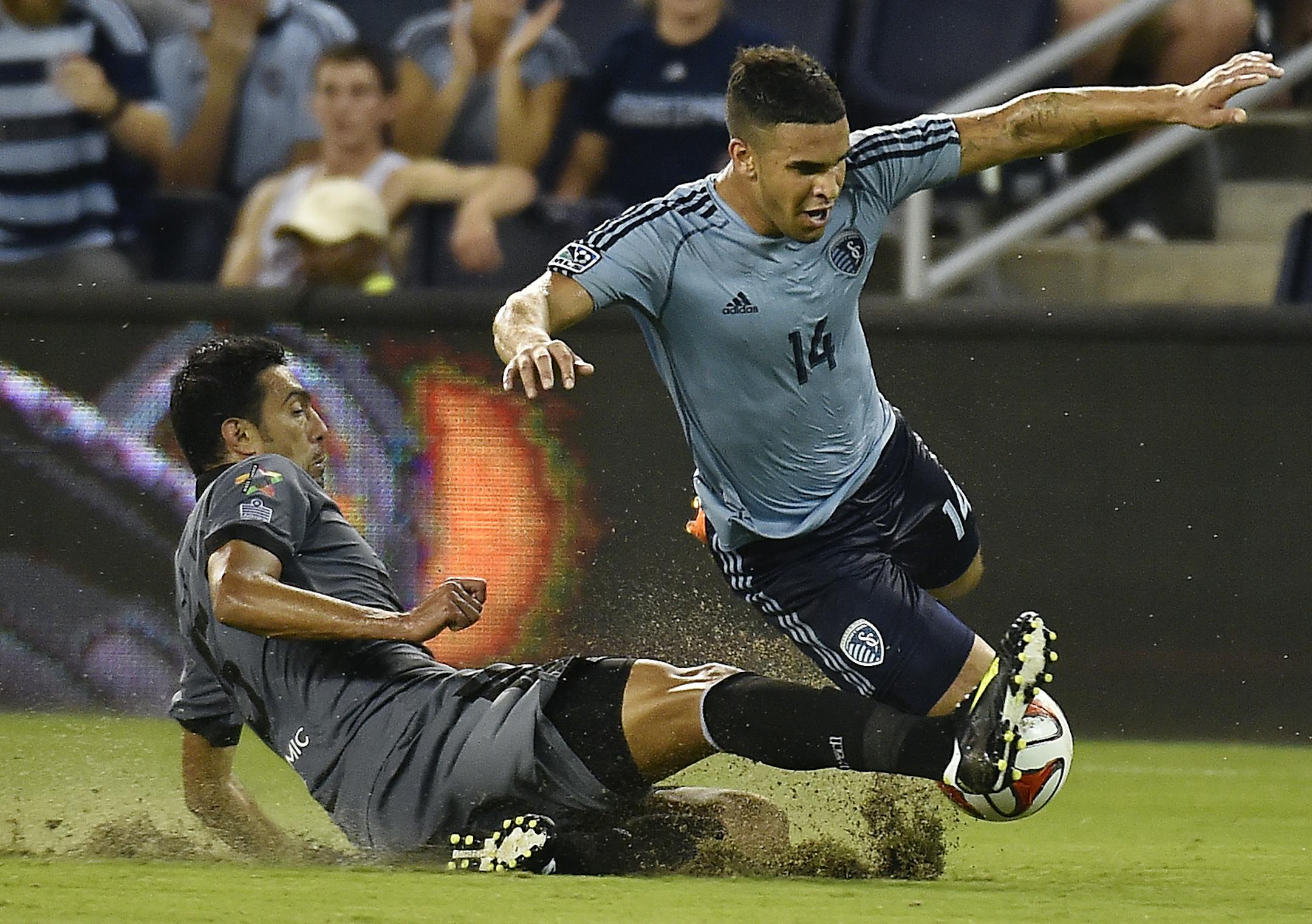 Sporting Kansas City defeated Minnesota United FC 2-0 in the fourth round of the Lamar Hunt U.S. Open Cup at Sporting Park Wednesday, June 18, 2014. As Sporting forward Dom Dwyer (right) was driving toward the goal, Minnesota defender Tiago Calvano (left) trips Dwyer up. After the ball got past them, Dwyer came back and tackled Calvano, resulting in a yellow card for Dwyer. ORG XMIT: B731738987Z.1