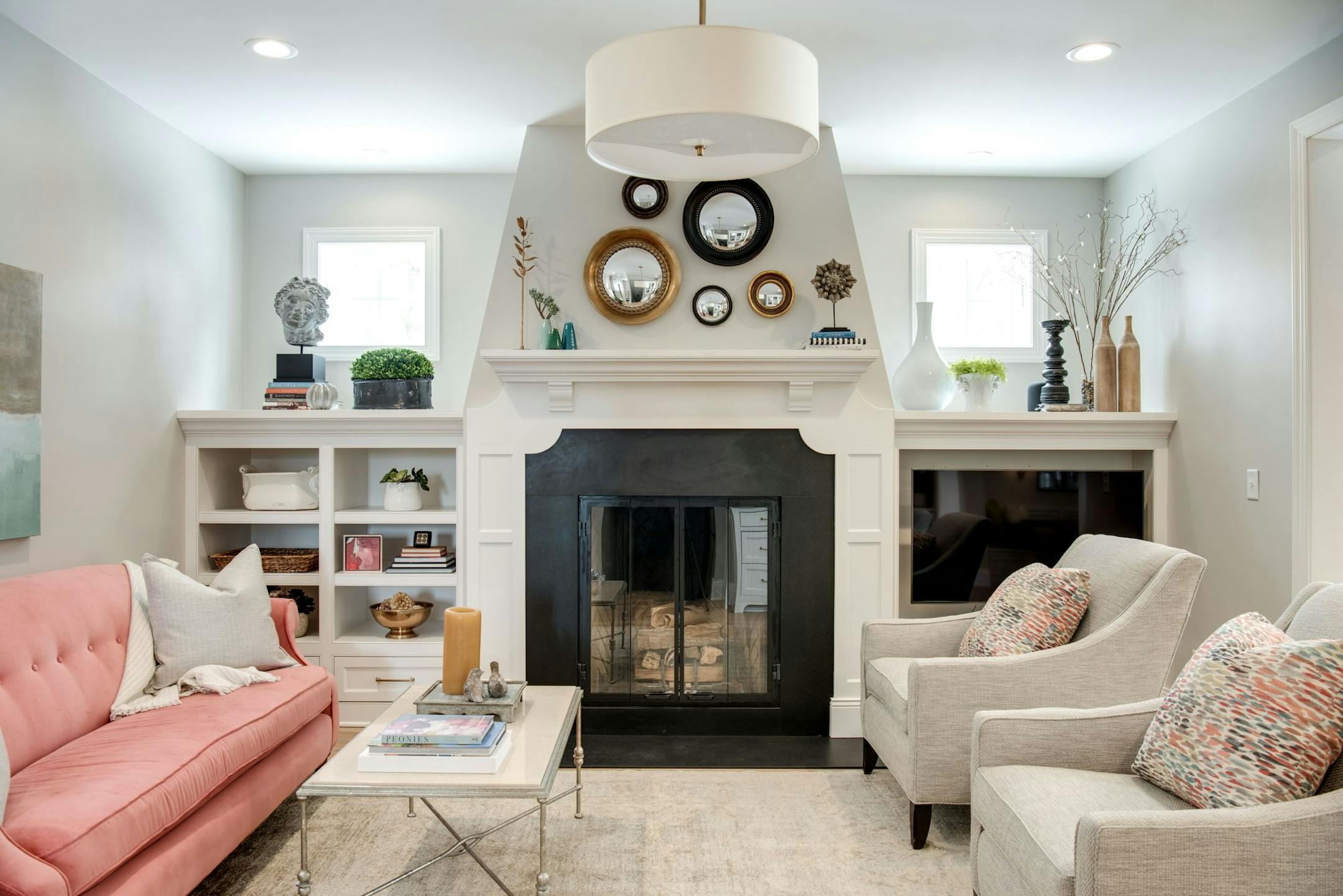 Interior designer Renae Keller added personality and pizazz to her newly built home in Burnsville with a bright coral sofa, an assortment of mirrors above the fireplace and other stylish design elements.