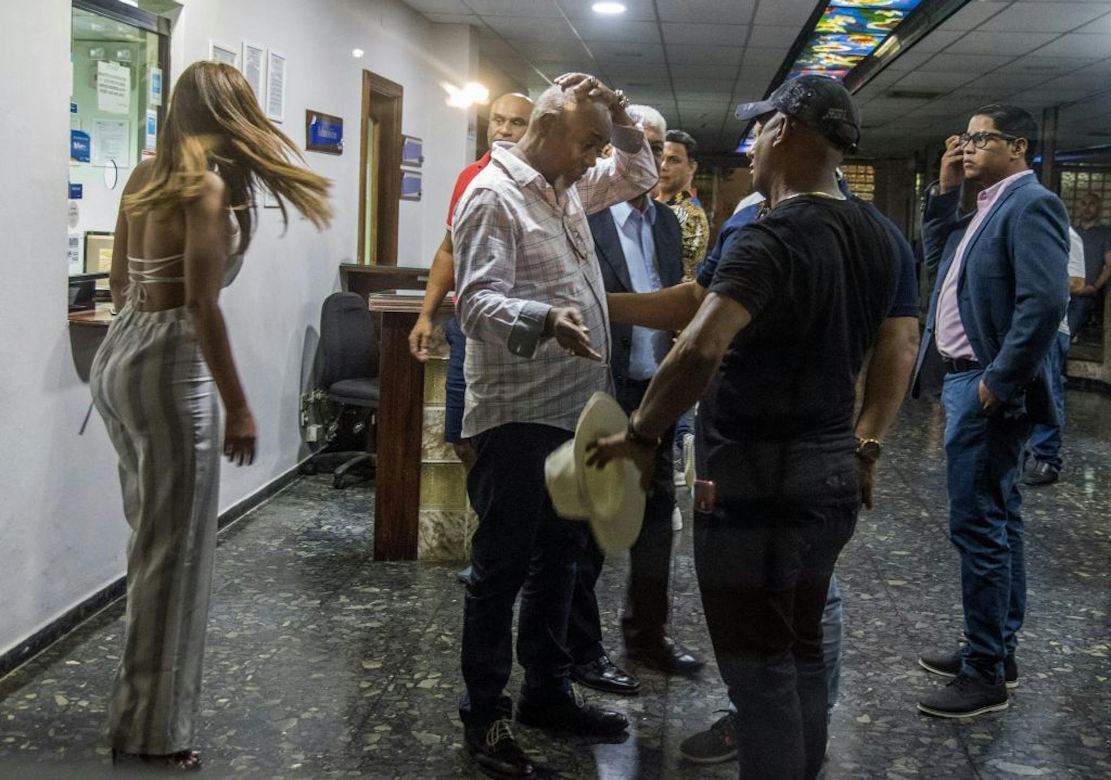 Leo Ortiz, center, father of former Boston Red Sox slugger David Ortiz talks with relatives at the hospital where his son was hospitalized after being shot in Santo Domingo, Dominican Republic.