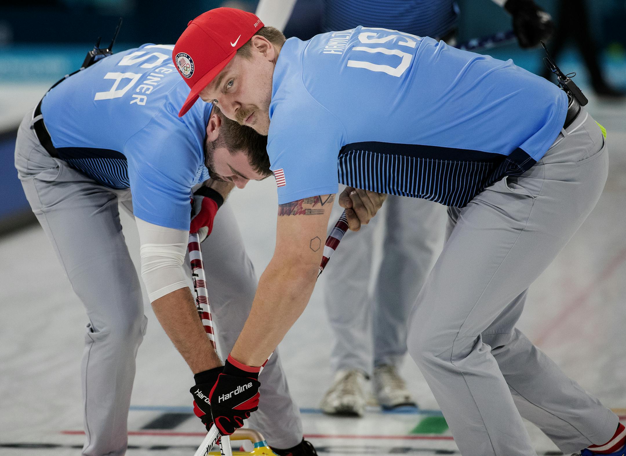 Matt Hamilton (right) and John Landsteiner swept in front of the rock during a competition vs. Denmark on Friday night. ] CARLOS GONZALEZ ¥ cgonzalez@startribune.com - February 16, 2018, South Korea, 2018 Pyeongchang Winter Olympics, Biathlon - Men's Curling, Gangneung Curling Center. USA vs. Denmark