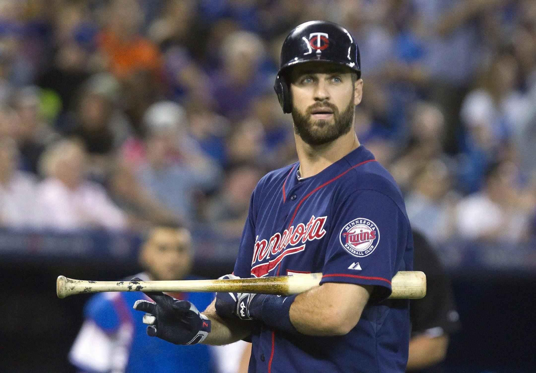 Minnesota Twins' Joe Mauer walks back to the dugout after striking out during the ninth inning of a baseball game against the Minnesota Twins, Tuesday, Aug. 4, 2015 in Toronto. (Fred Thornhill/The Canadian Press via AP) MANDATORY CREDIT