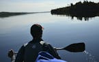 Paddling a canoe on Gunflint Lake in the Boundary Waters Canoe Area Wilderness.