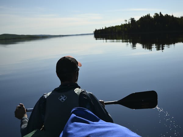 Paddling a canoe on Gunflint Lake in the Boundary Waters Canoe Area Wilderness.