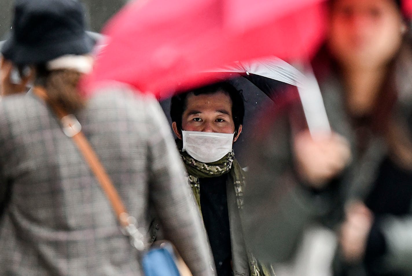 A man wore a face mask in Duesseldorf, Germany, on Wednesday. Americans should brace for the likelihood that the coronavirus will spread to communities in the United States, health officials in Minnesota and the U.S. warned.