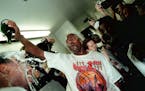 Michael Jordan pours bubbly on Dennis Rodman inside the locker room after winning the NBA title on June 14, 1998.
