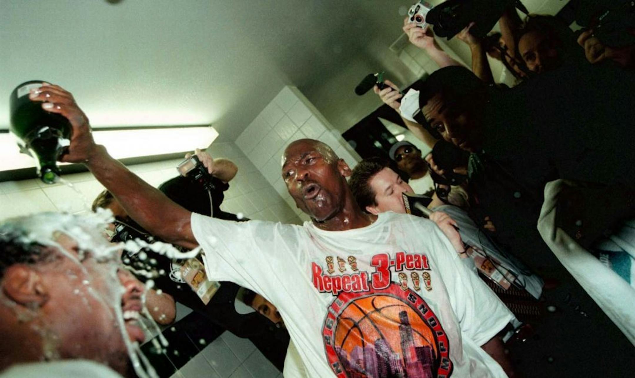 Michael Jordan pours bubbly on Dennis Rodman inside the locker room after winning the NBA title on June 14, 1998.