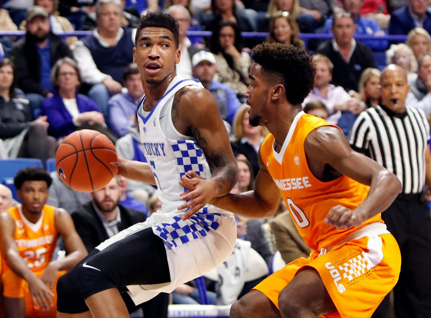 Kentucky's Malik Monk, left, looks for an opening as Tennessee's Jordan Bone (0) defends during the first half of an NCAA college basketball game, Tuesday, Feb. 14, 2017, in Lexington, Ky. (AP Photo/James Crisp)