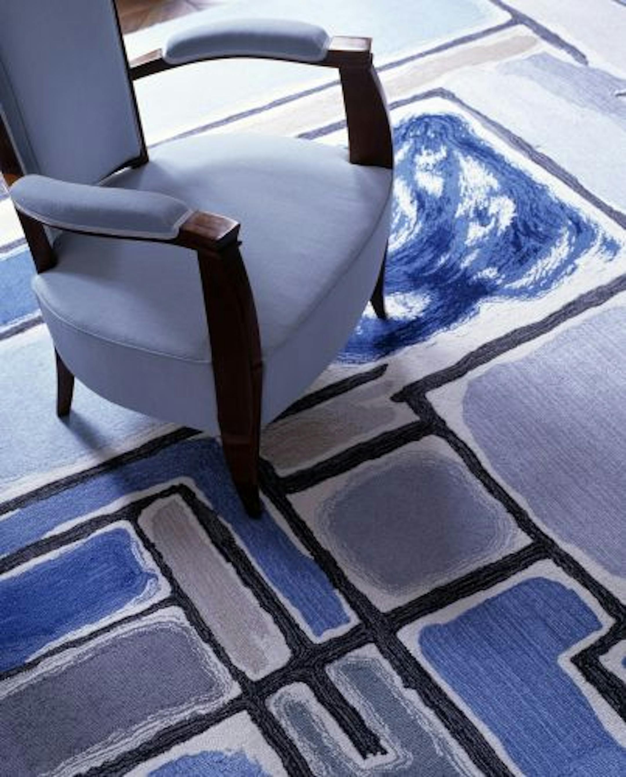 Diamond Baratta's Mondrian-inspired custom rug pairs with solid-color upholstery in the home of clients who love modern art.