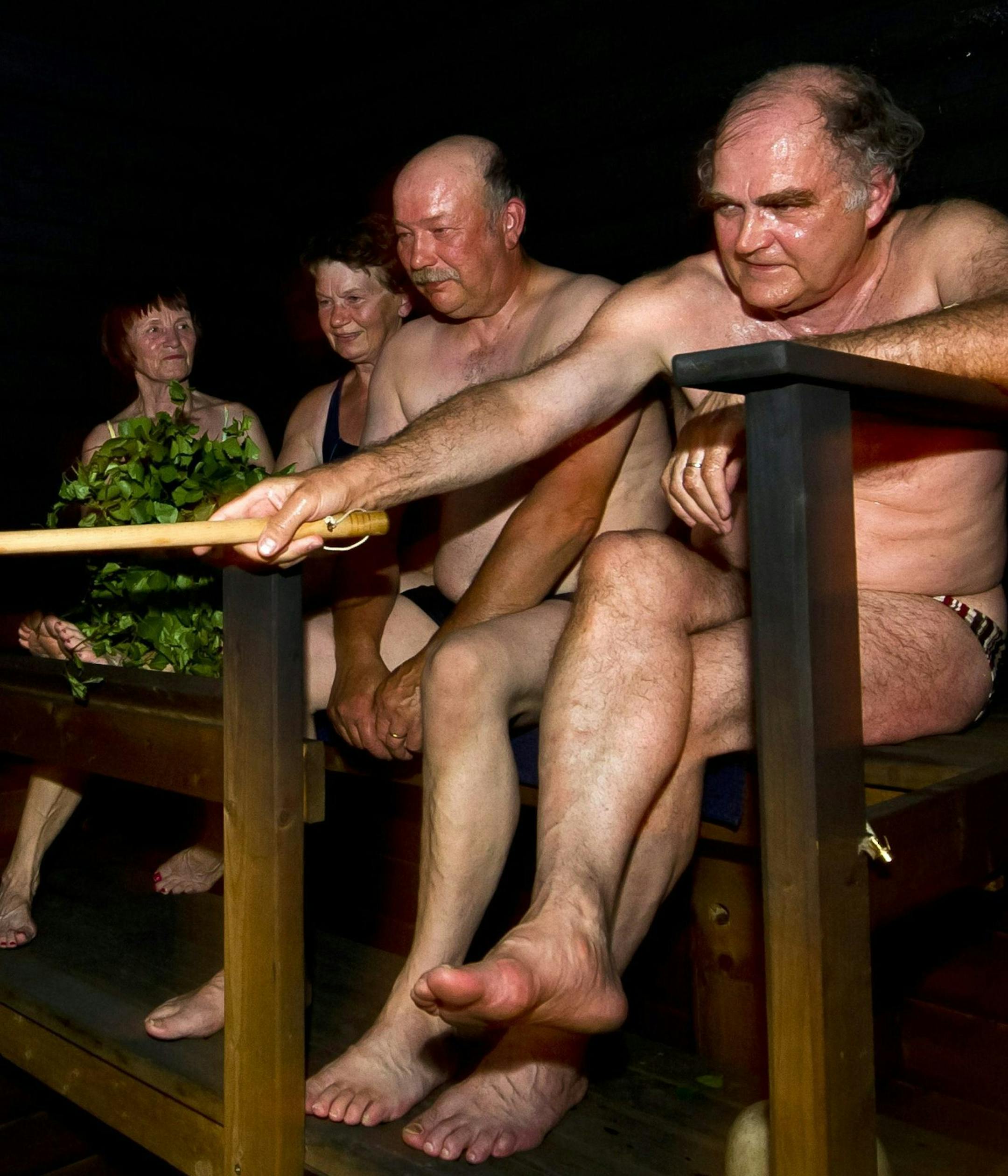 In this July 18, 2012 photo, people sit in a sauna at a Finnish summer cottage, in Leppavirta, central Finland. Frequent sauna baths may help you live longer, a study of Finnish men suggests. (AP Photo/Lehtikuva, Roni Rekomaa) FINLAND OUT