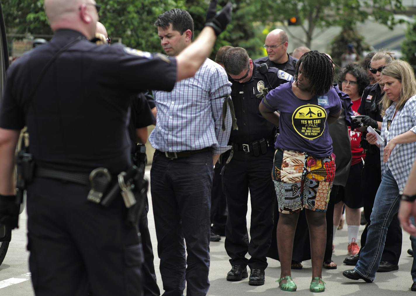 At the MSP airport on June 16, 2014, SEIU members and supporters demanded higher wages for the service workers that work there About a dozen were arrested for blocking traffic in the passenger drop off area .]richard.tsong-taatarii/rtsong-taatarii@startribune.com