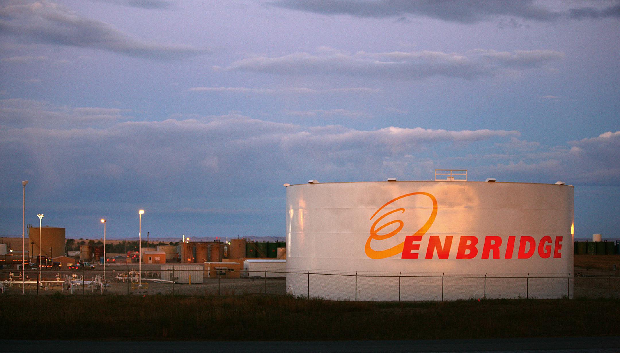 Enbridge Inc. signage is displayed at the company's facility outside of Alexander, North Dakota, U.S., on Thursday, Oct. 13, 2011. Oil production in the state has tripled in five years, attracting the likes of Exxon Mobil Corp., and Norway's Statoil ASA, which agreed this week to pay $4.5 billion for Brigham Exploration Co., one of the companies that figured out how tap dense rock that the U.S. Geological Survey has estimated may contain 4.3 billion barrels of oil. The productive Bakken formatio