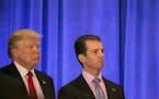FILE -- President-elect Donald Trump and his son Donald Trump Jr. at Trump Tower in New York, Jan. 11, 2017. Two weeks after Trump clinched the Republ