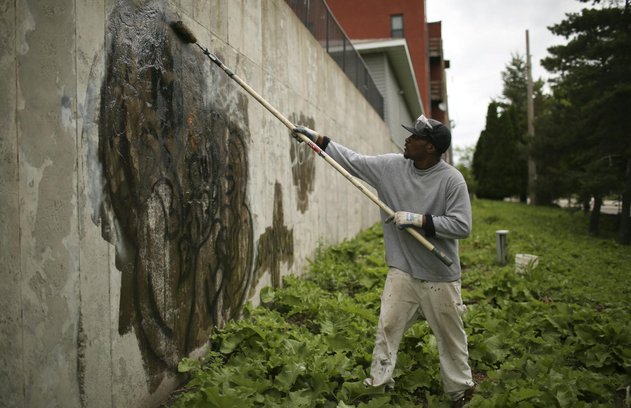 Robert rolled a thick solvent over a graffiti tag on a retaining wall near I-35W Thursday afternoon. After scrubbing it, he power washed it to remove most of the paint. ] JEFF WHEELER &#x201a;&#xc4;&#xa2; jeff.wheeler@startribune.com Robert from the St. Paul Parks and Recreation department, who doesn't want his last name used for fear of retaliation, is the city's lead foot soldier in the war on graffiti. He removes graffit in as many as ten locations a day, every day he works. Thursday afternoo