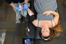 Therese Kulas donates blood during a Red Cross blood drive at Union Depot in St. Paul on Thursday, June 20.