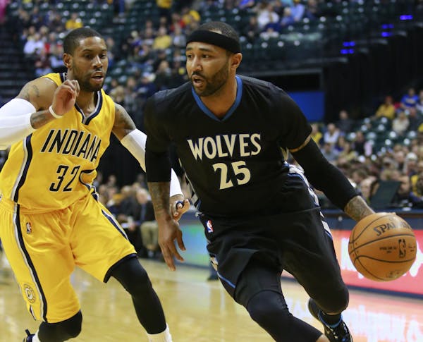 Minnesota Timberwolves guard Mo Williams (25) dribbles the basketball guarded by Indiana Pacers guard C.J. Watson in the first half of an NBA basketba
