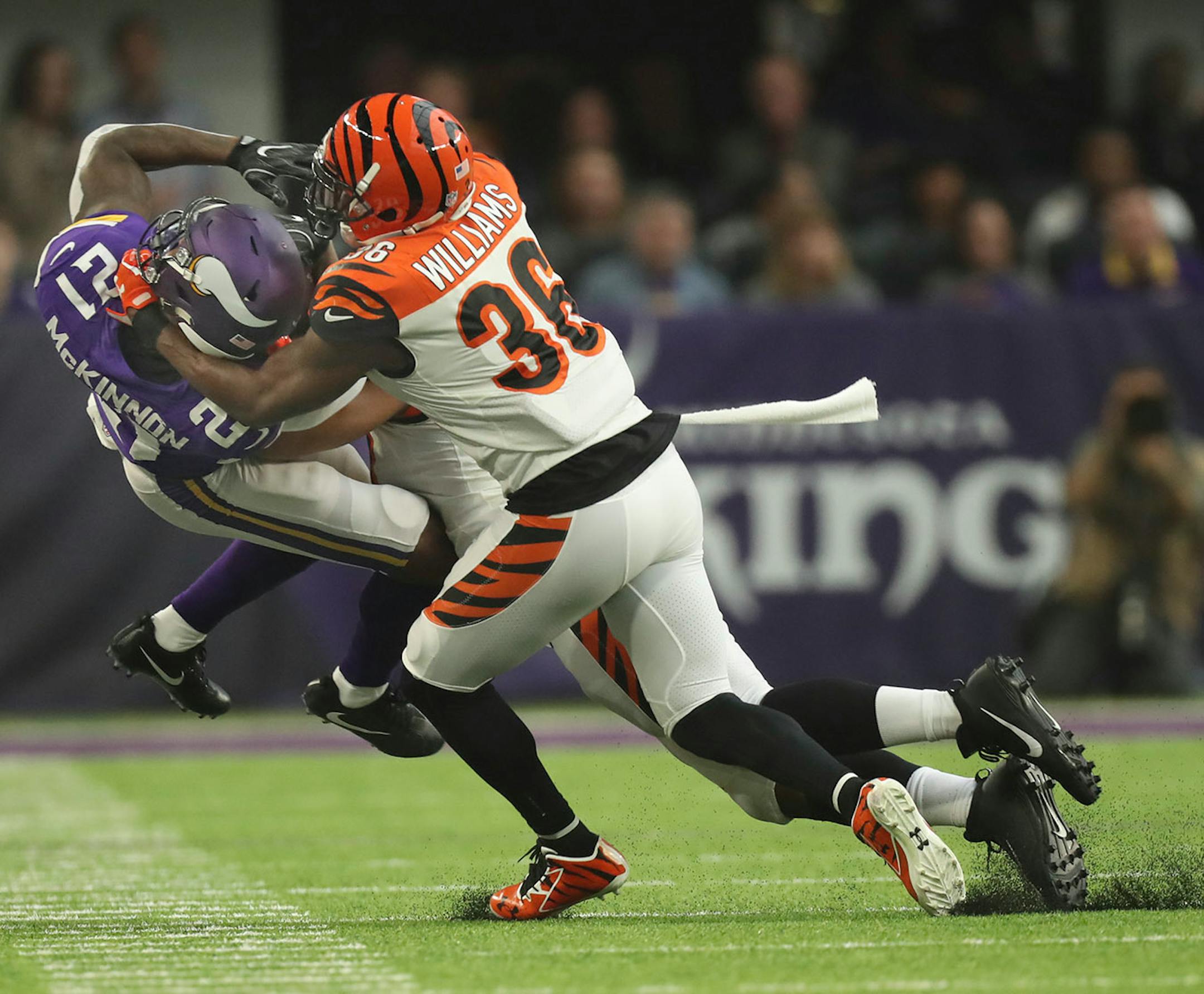 Vikings running back Jerick McKinnon (21) was taken down by Bengals strong safety Shawn Williams (36) after catching a pass for a short gain in the second quarter on Sunday at U.S. Bank Stadium.