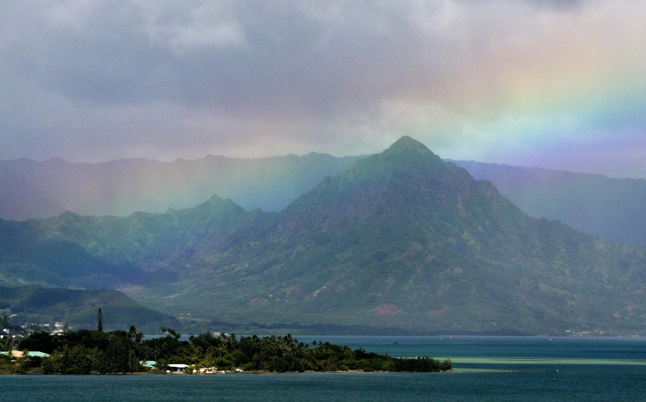 President Barack Obama's motorcade passes Kaneohe Bay as heads for the beach at Bellows Air Force Station, Saturday, Jan. 3, 2015, on the island of Oahu in Hawaii, on the final day of the Obama family vacation. (AP Photo/Jacquelyn Martin)