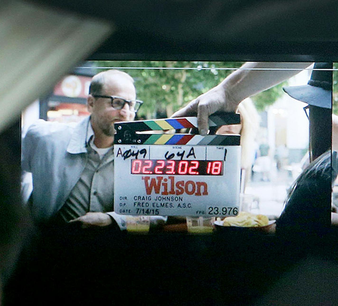 From behind the set of the new Woody Harrelson movie, "Wilson," a tech monitors video screens of the filming inside a tent Tuesday, July 14, 2015,which is shooting at the Mall of America, in Bloomington, Minn.