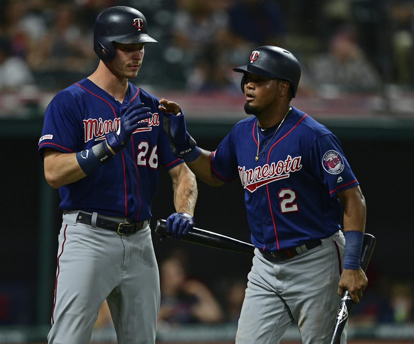 Minnesota Twins' Luis Arraez, right, is congratulated by Max Kepler after scoring a run on a two-RBI double in the eighth inning of a baseball game against the Cleveland Indians, Saturday, July 13, 2019, in Cleveland. (AP Photo/David Dermer)