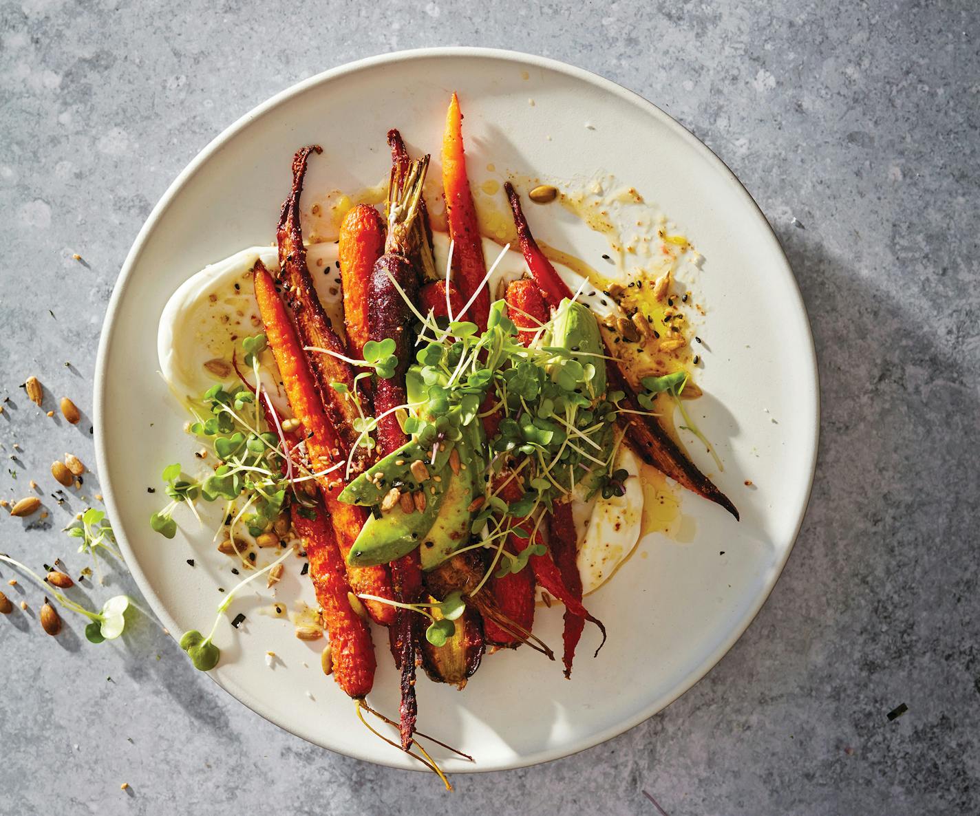 Roasted carrots on a smear of yogurt and topped with avocados, furikake seeds and microgreens.