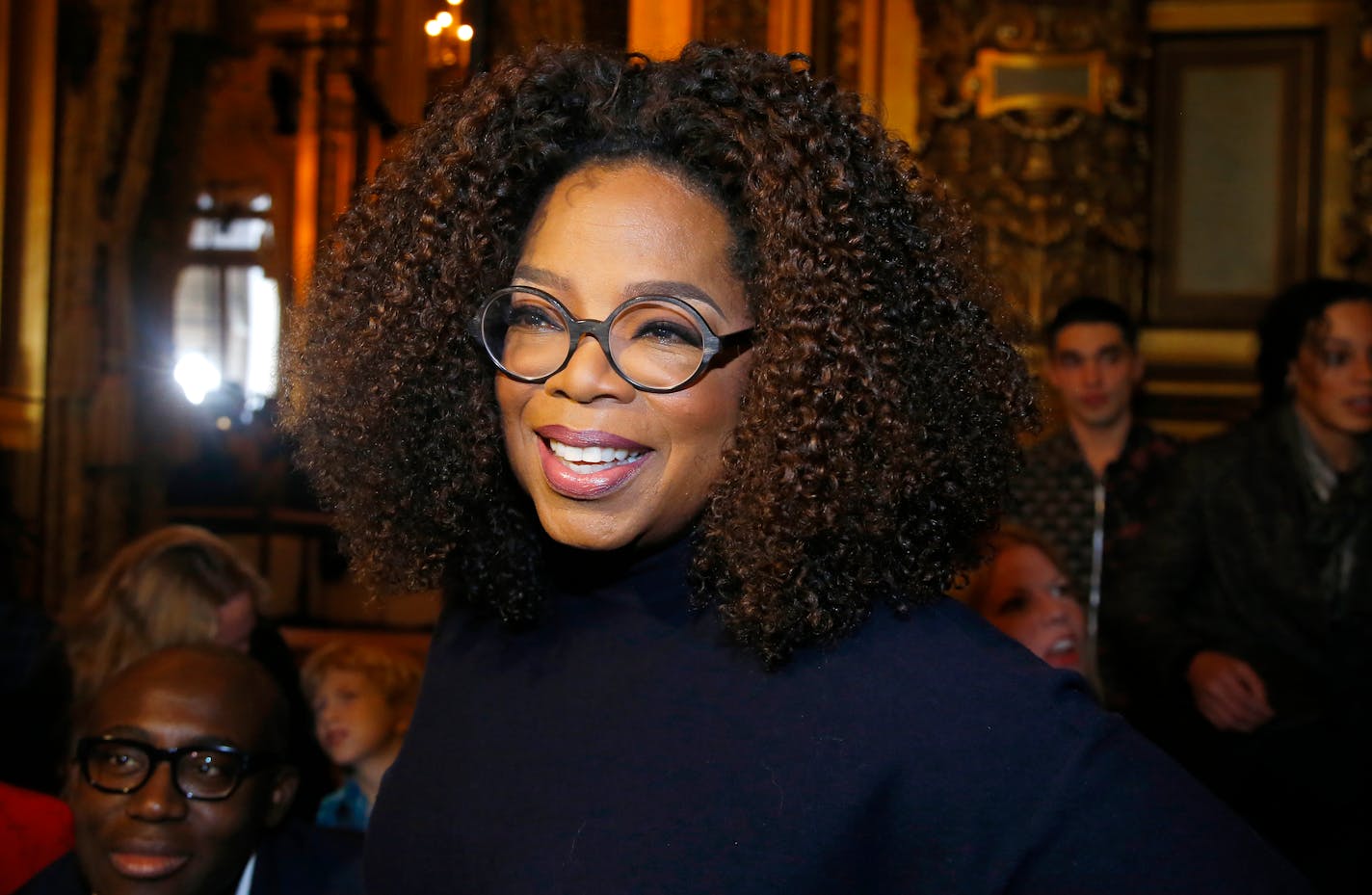 FILE - Oprah Winfrey arrives for the presentation of Stella McCartney's ready-to-wear Fall-Winter 2019-2020 fashion collection in Paris on March 4, 2019. Winfrey is setting aside her usual book club recommendations and instead citing seven personal favorites ranging from James Baldwin's landmark essays in "The Fire Next Time" to Mary Oliver's poetry collection "Devotions." She is calling her choices "The Books That See Me Through," works she values for "their ability to comfort, inspire, and enlighten" her. (AP Photo/Michel Euler, File)