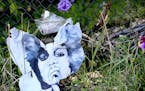 A weathered, torn portrait of Prince sits along the fence, outside Paisley Park on May 14, 2016.