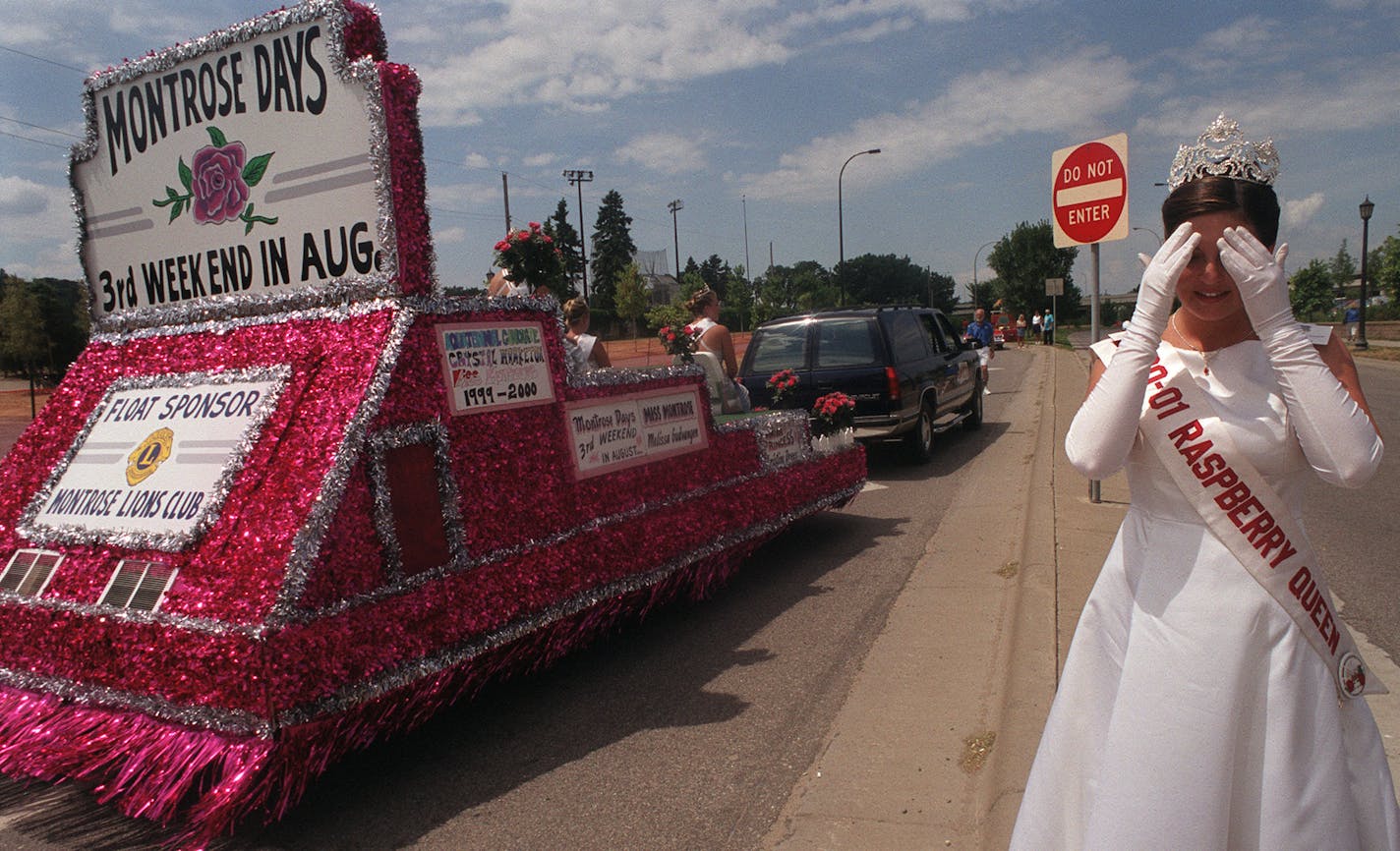 GENERAL INFORMATION: minn.mn-7/14/01-aquatennial grande day parade.
IN THIS PHOTO: Hopkins Raspberry Festival Queen Melissa Specken takes a moment to freshen up after finishing the Grande Day Parade in 94 degree heat Saturday afternoon.