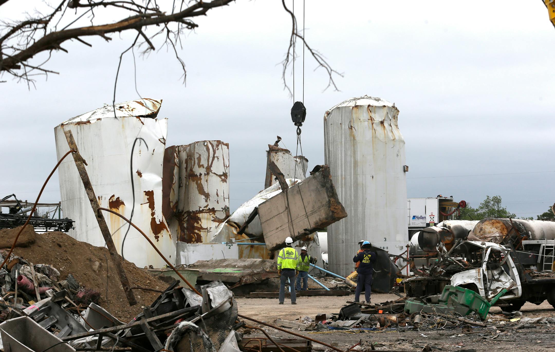 In this May 2, 2013, file photo investigators move and look through the debris of the destroyed fertilizer plant in West, Texas. Texas law enforcement officials launched a criminal investigation Friday, May 10, 2013, into the massive explosion last month that killed 14 people.