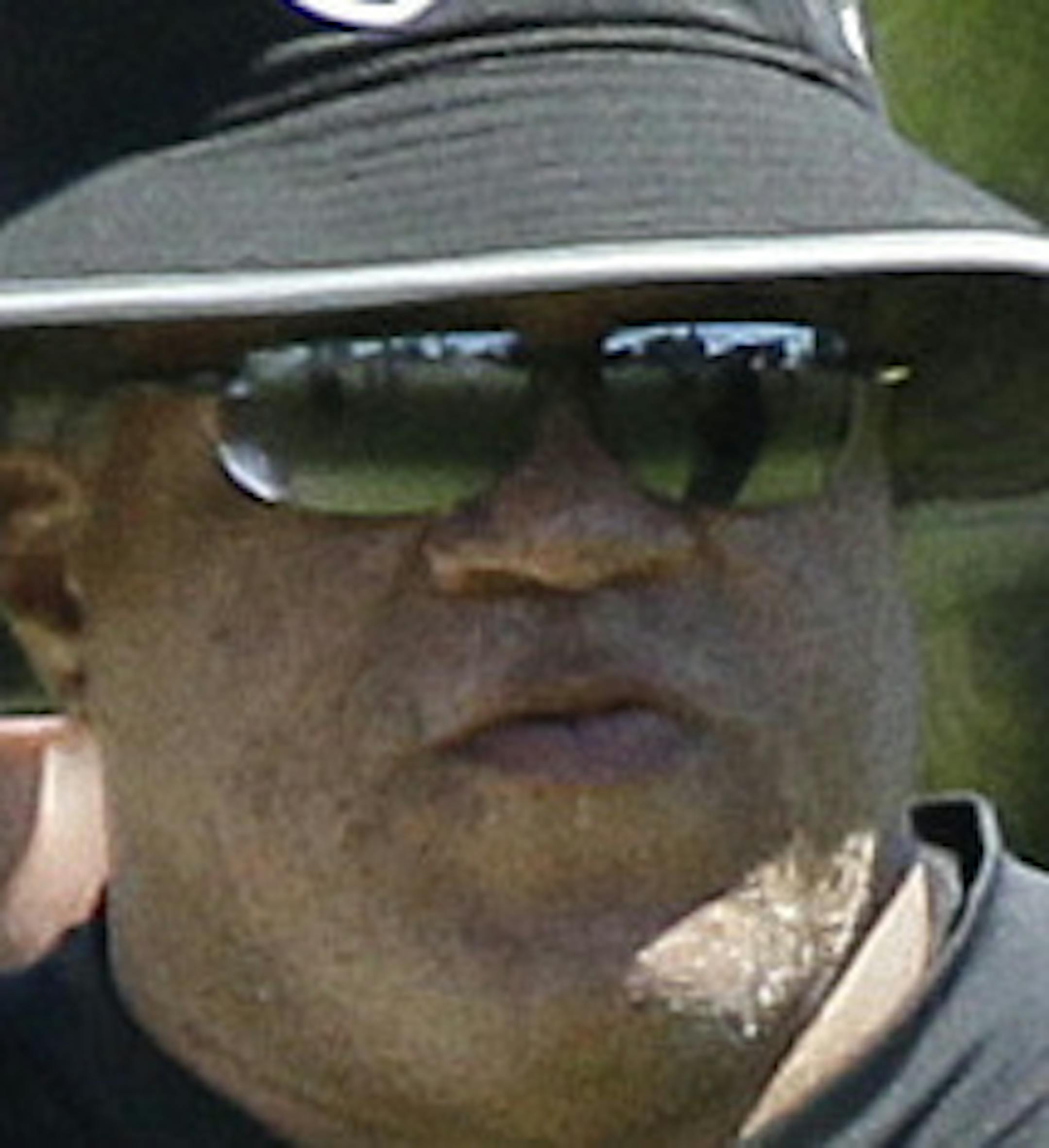 Oakland Raiders general manager Reggie McKenzie, center, watches practice at the NFL football team's training camp Saturday, July 30, 2016, in Napa, Calif. The Raiders signed McKenzie to a four-year contract extension. Owner Mark Davis announced the move Friday night in front of about 100 former Raiders players. (AP Photo/Eric Risberg)