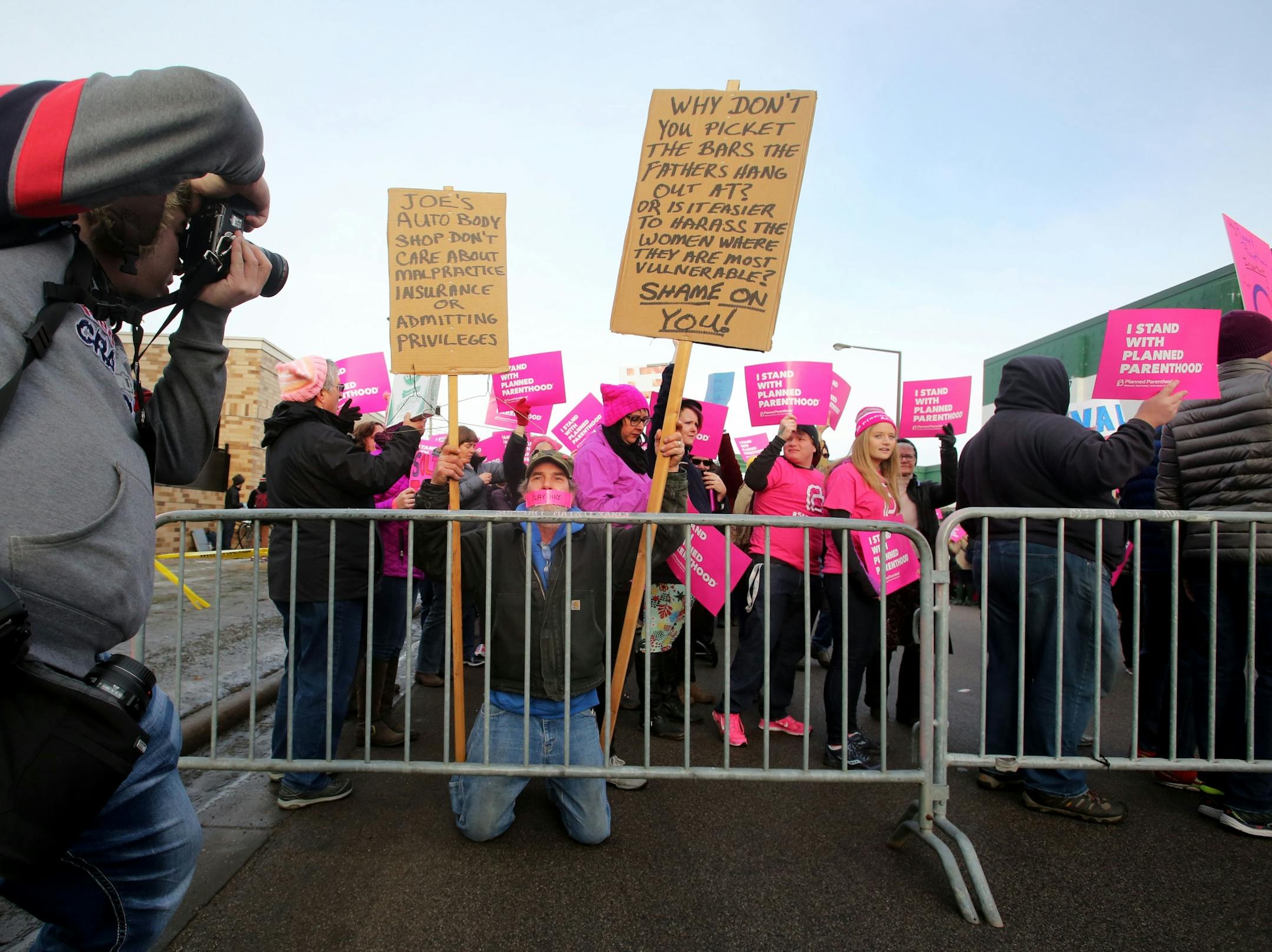 Craig Rice of Newport, a supporter of Defend Planned Parenthood, kneeled near a police barricade where on the other side were supporters of Pro-Life Action Ministries. Rice, who said he was adopted, said he supported a women's right to choose because his mother had instilled in him the belief in a women's right for access and safety. Rice said his mother was an opponent of Trump and died on his inauguration day.