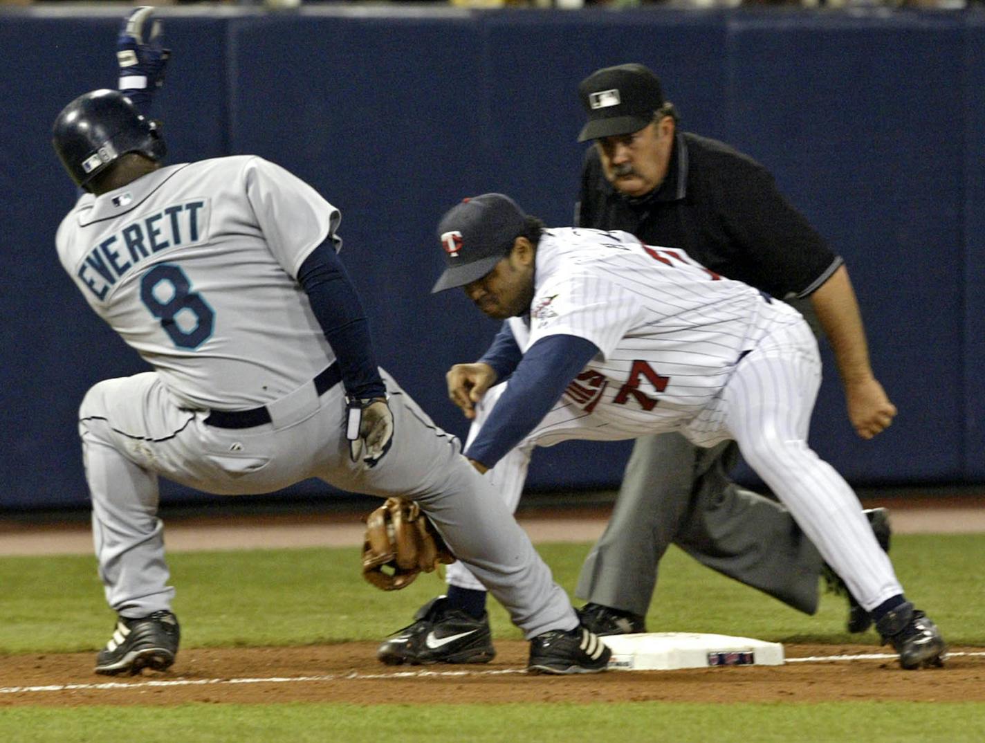 The Twins pulled off a triple play in the eighth inning after Seattle loaded up the bases on May 27, 2006. Here, Tony Batista tags out Carl Everett for the third out