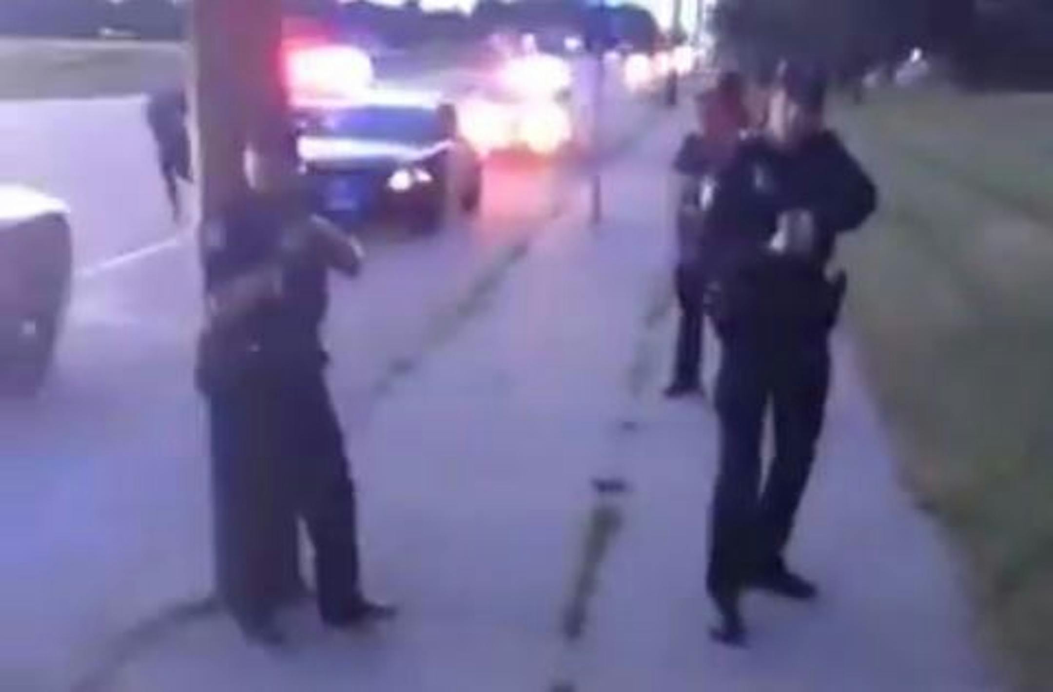 In a scene from the video of the Falcon Heights shooting aftermath, the woman filming exits the car under orders from police.
