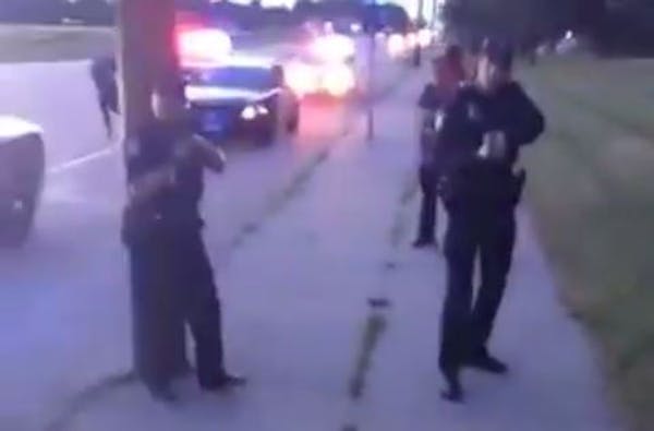 In a scene from the video of the Falcon Heights shooting aftermath, the woman filming exits the car under orders from police.