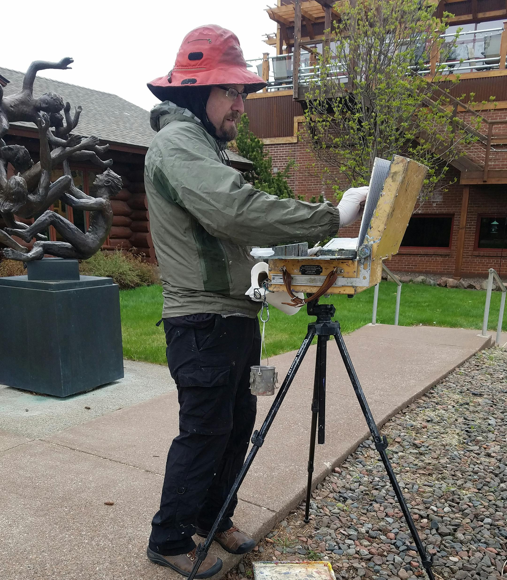 Greg Lecker is an plein artist, and is shown working in Grand Marais.