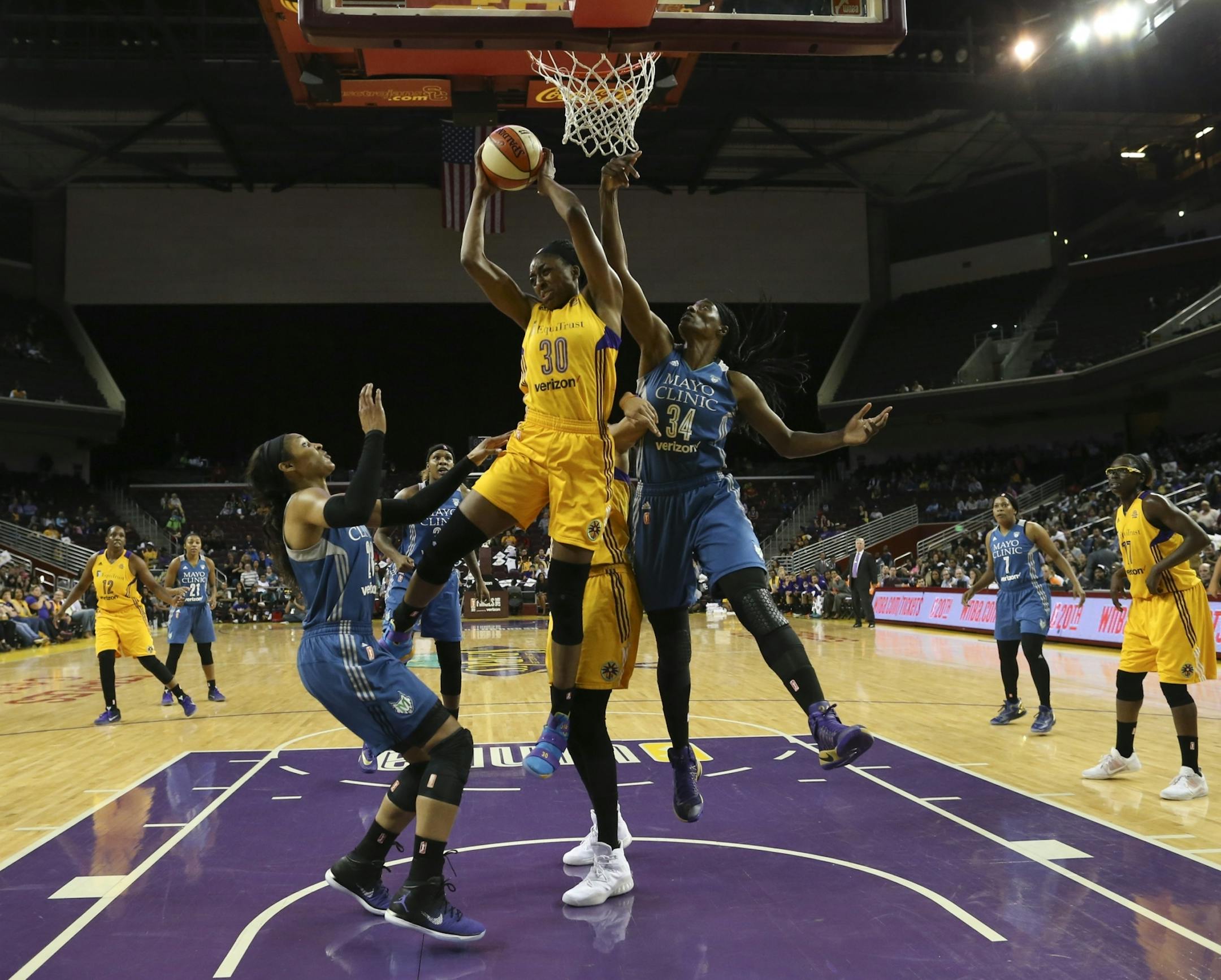 Los Angeles Sparks forward Nneka Ogwumike (30) grabbed a defensive rebound ahead of Lynx forward Maya Moore (23) and center Sylvia Fowles (34) in the first half.