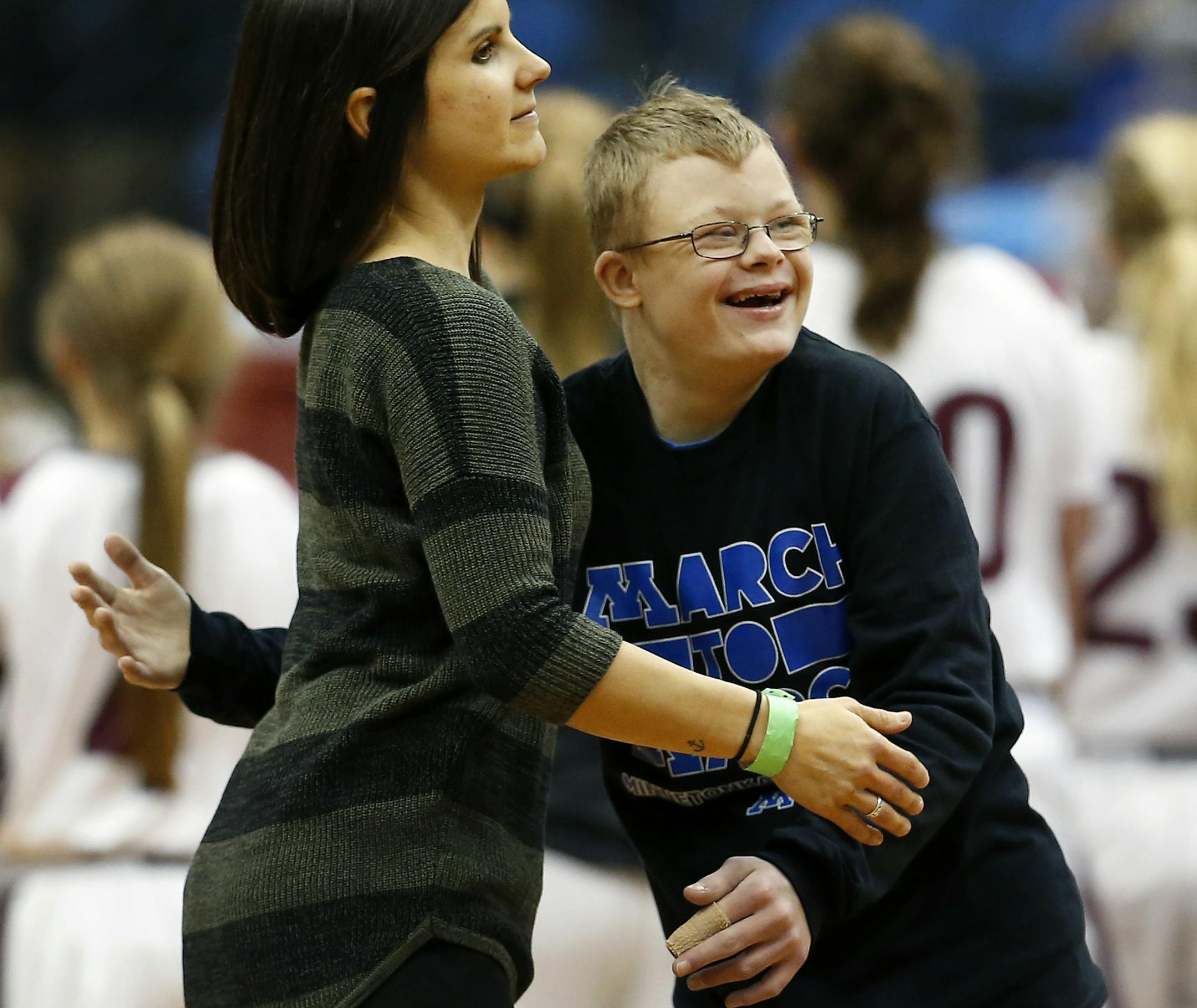 Minnetonka student manager Lucas Hagen got a hug from assistant coach Stacie Olson at the end of the game. ] CARLOS GONZALEZ cgonzalez@startribune.com - March 15, 2016, Minneapolis, MN, Target Center, Minnesota State High School / Prep Girls Basketball state tournament quarterfinals Class 4A Minnetonka vs. Anoka
