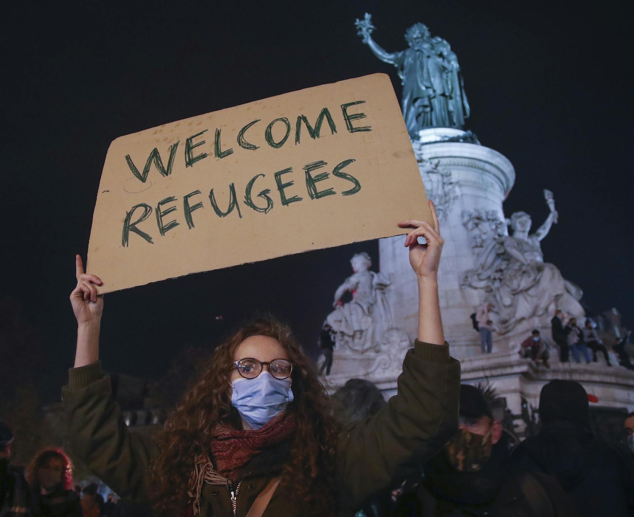 A demonstrator on Tuesday rallied at the Place de la République in Paris over a crackdown on a migrant camp.