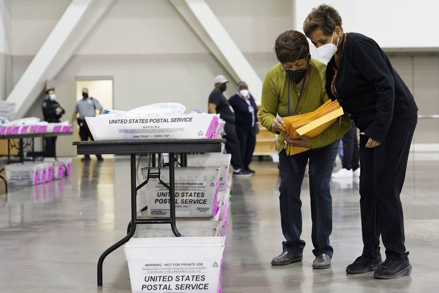 Election officials work around ballots during a hand recount of presidential votes at the Wisconsin Center, Friday, Nov. 20, 2020, in Milwaukee.