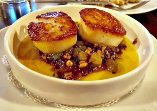 A pair of sea scallops, seared with a hint of cumin and resting in a dreamy blend of brown butter, golden raisins and pine nuts.