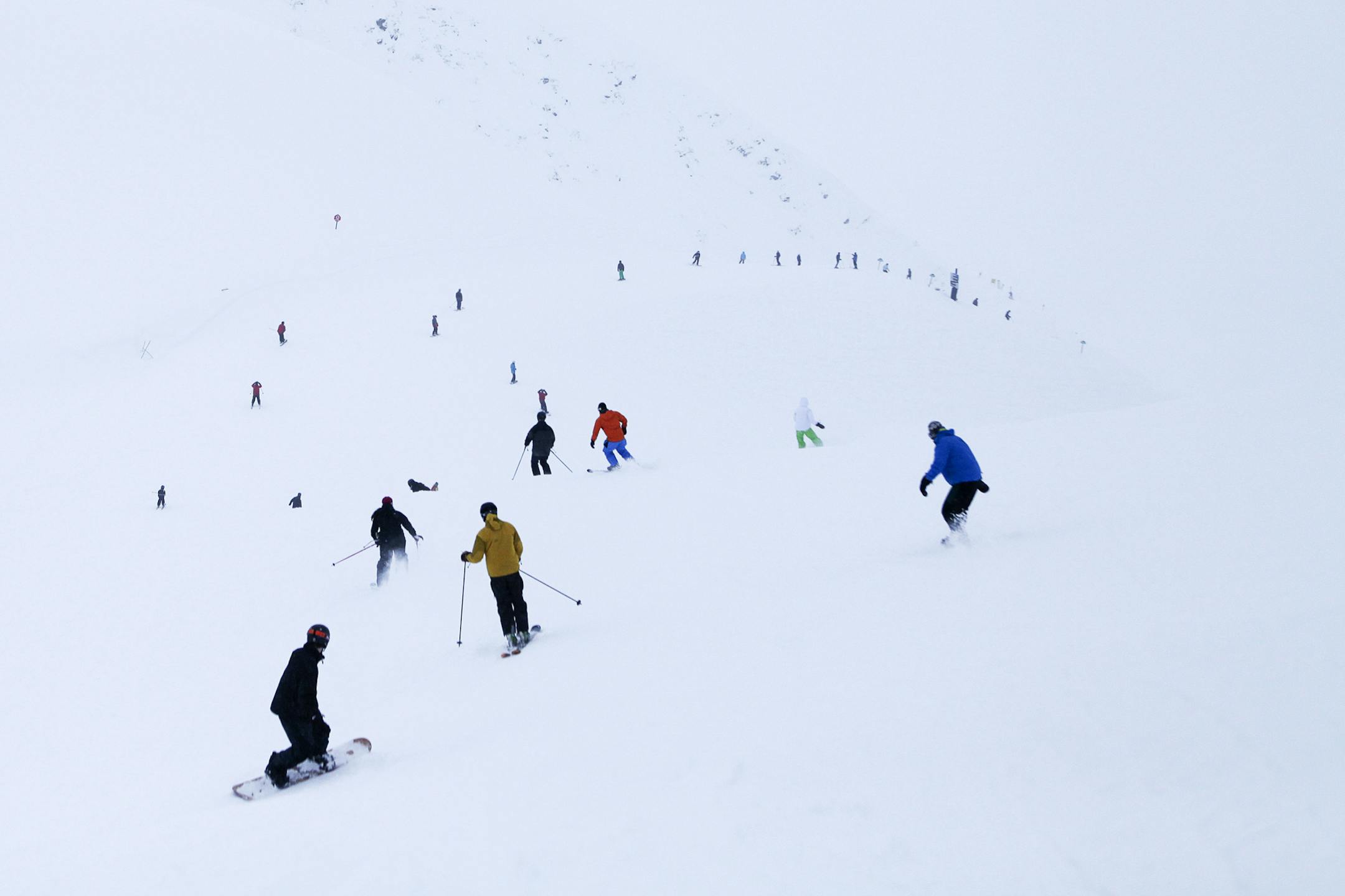 Skiers and snowboarders on a downhill run at the Alyeska Resort in Girdwood, Alaska, Jan. 19, 2013. Ski resorts around Anchorage must light trails in winter so that guests can ski past 2:30 p.m., but some locals say a good ski is one of the few things that make Alaska's winters bearable. (Tara Todras-Whitehill/The New York Times) -- PHOTO MOVED IN ADVANCE AND NOT FOR USE - ONLINE OR IN PRINT - BEFORE FEB. 23, 2014. ORG XMIT: XNYT118