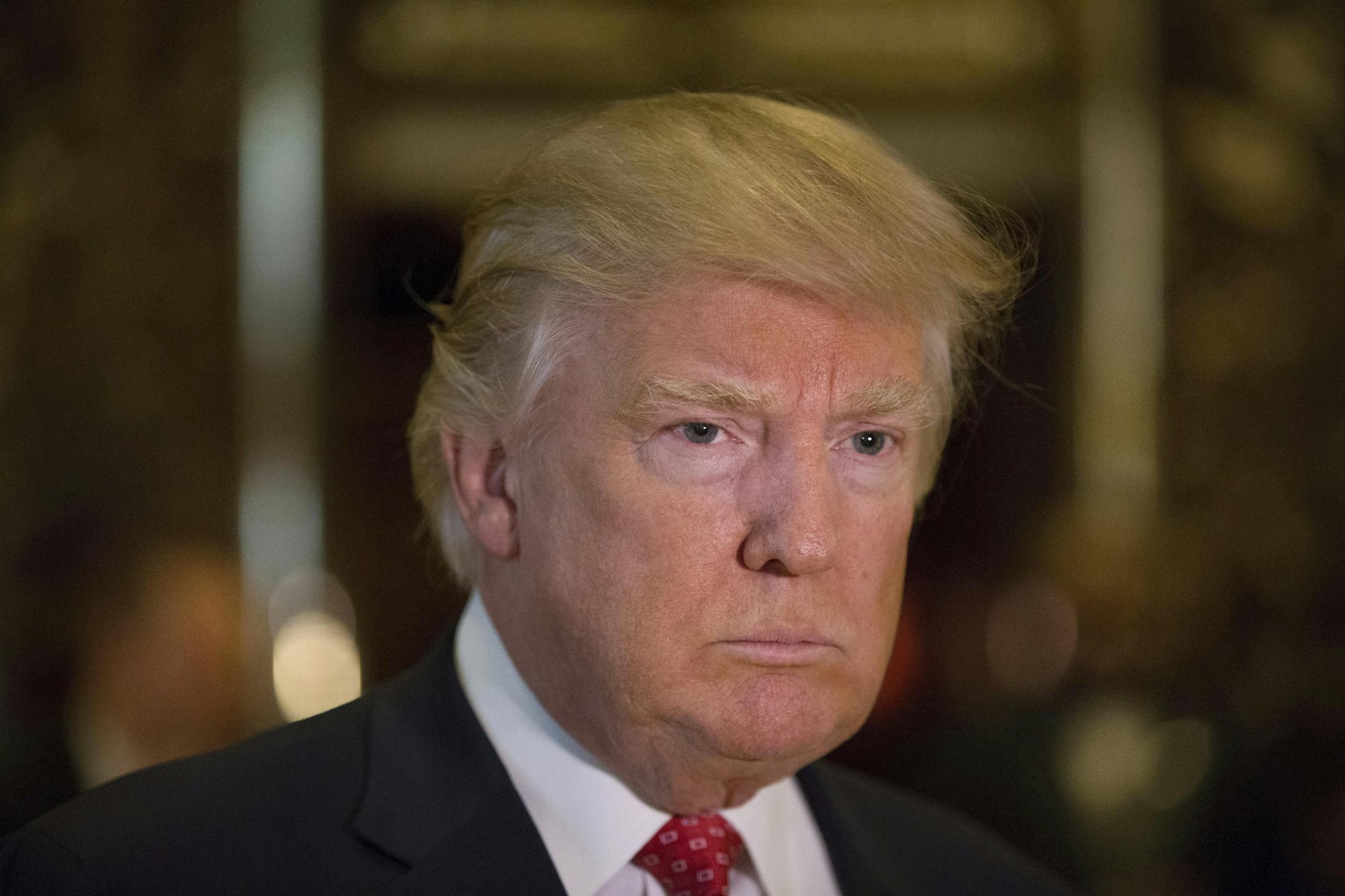 President-elect Donald Trump talks to reporters in the lobby of Trump Tower on Fifth Avenue in New York, Jan. 9, 2017. (Kevin Hagen/The New York Times)