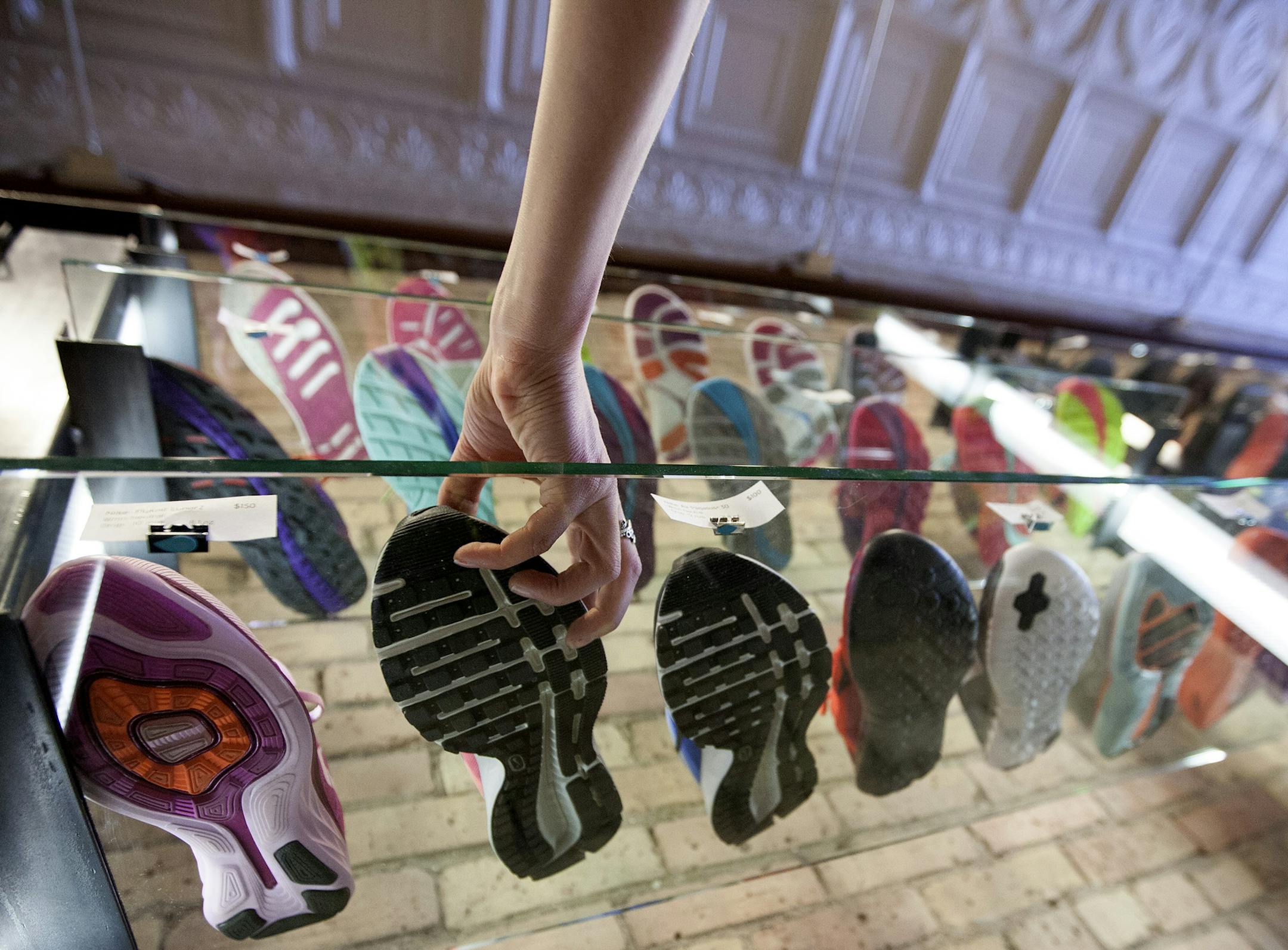 Co-owner Bekah Metzdorff reaches for a shoe at Mill City Running in Minneapolis May 3, 2014. (Courtney Perry/Special to the Star Tribune)