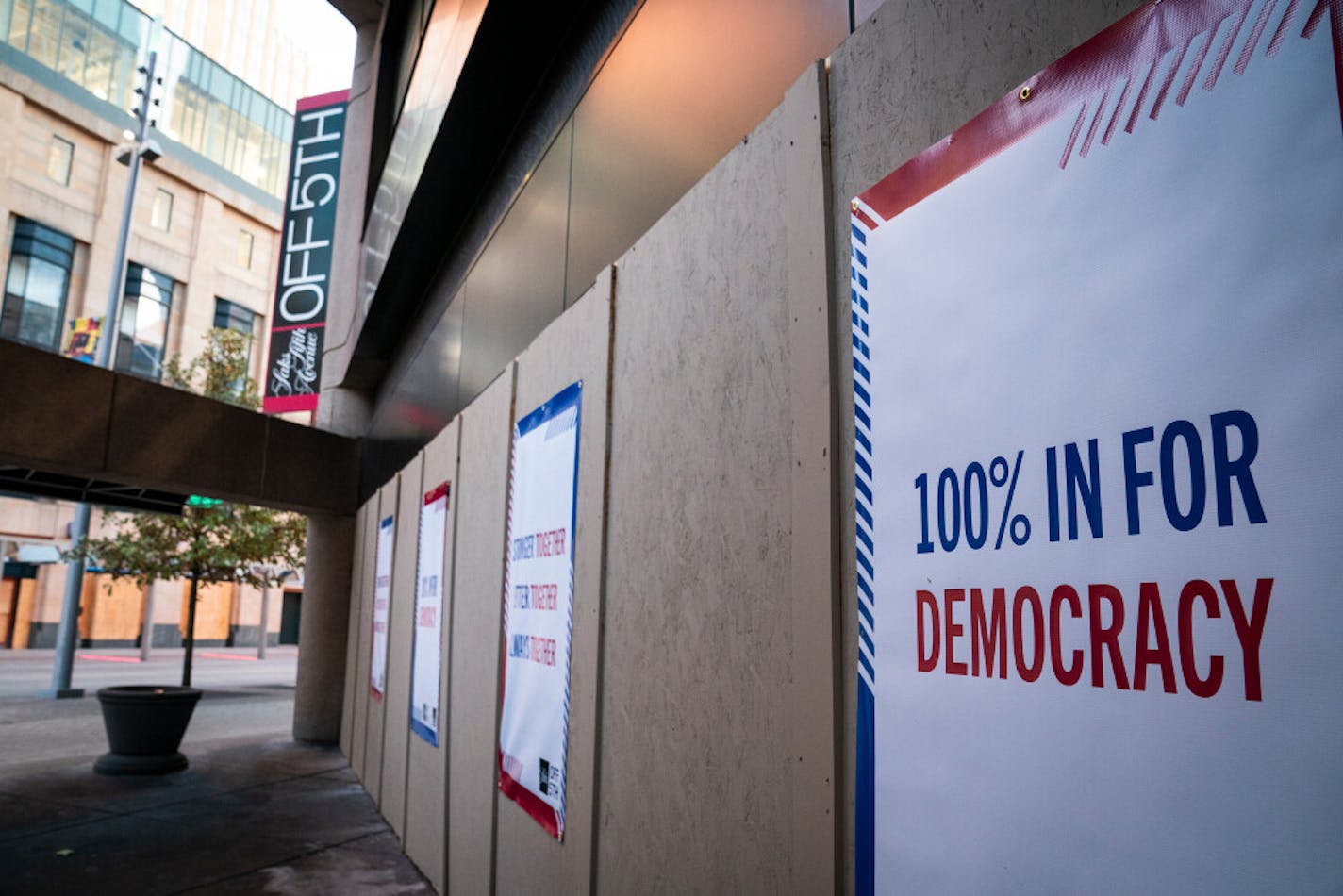 Signs on the boarded-up windows outside Saks Fifth Avenue Off Fifth store in downtown Minneapolis on Monday, Nov. 2.