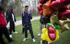 Friend Jordan Rhondes, 18, kissed his finger and placed it on a memorial at the site of the fatal shooting of 18-year-old Bobby Davion on Sunday. Phot