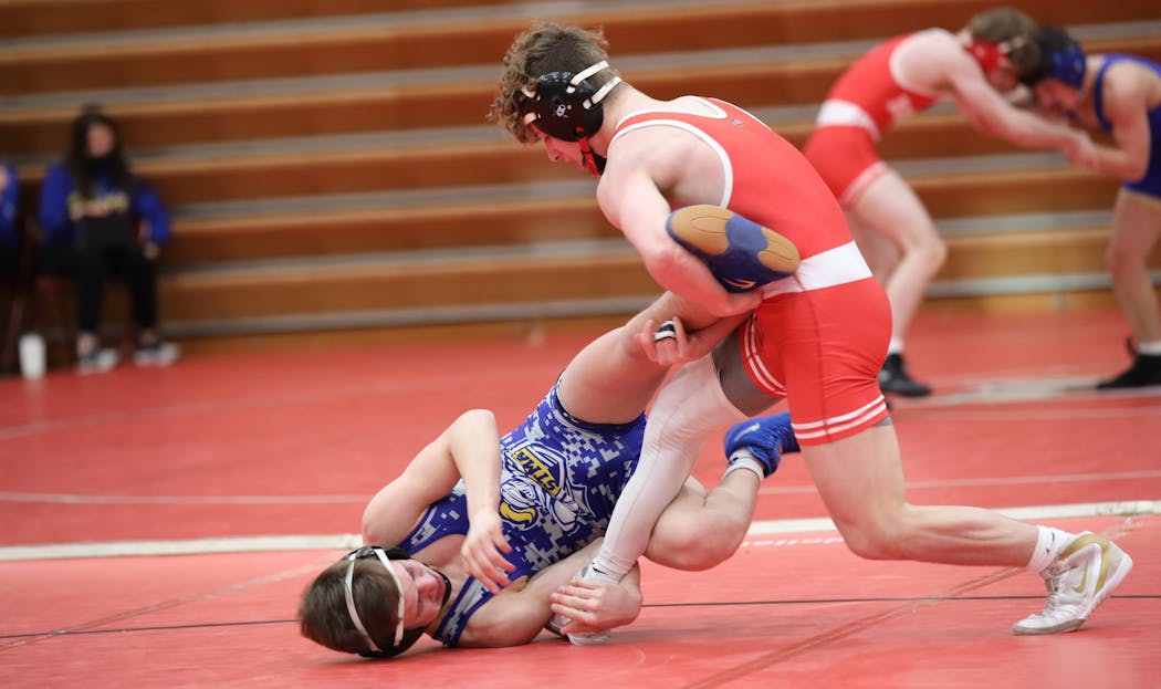 Lakeville North junior Jore Volk took down St. Michael-Albertville’s Landon Robideau in a match between the No. 1 and No. 2 wrestlers in Class 3A at 120 pounds on Thursday. Volk went on to win 8-3.
